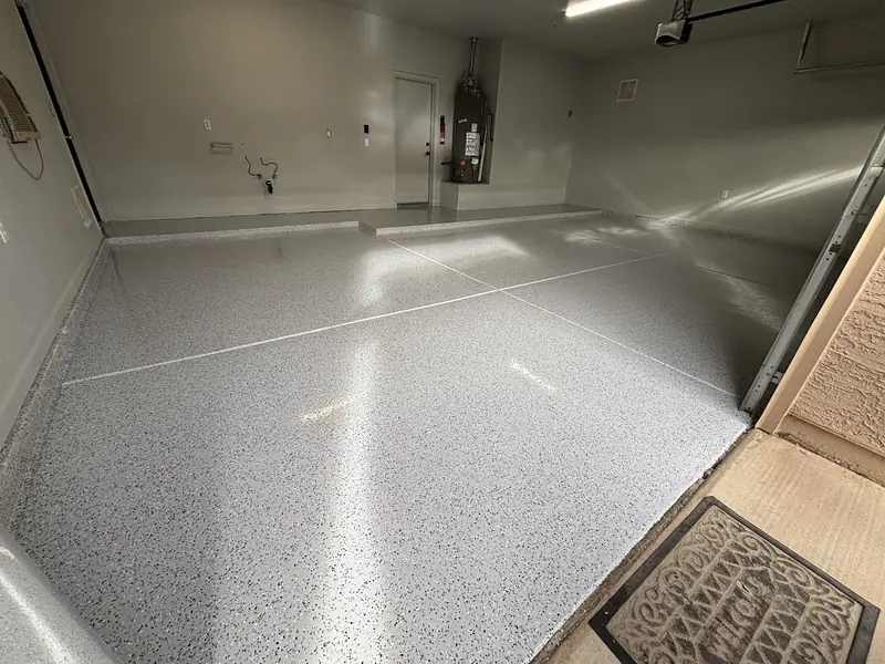 Light grey flake epoxy garage floor with a high-gloss finish