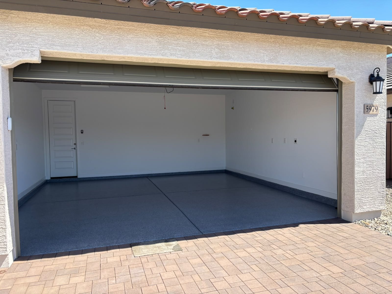 Finished grey flake garage floor seen from the driveway